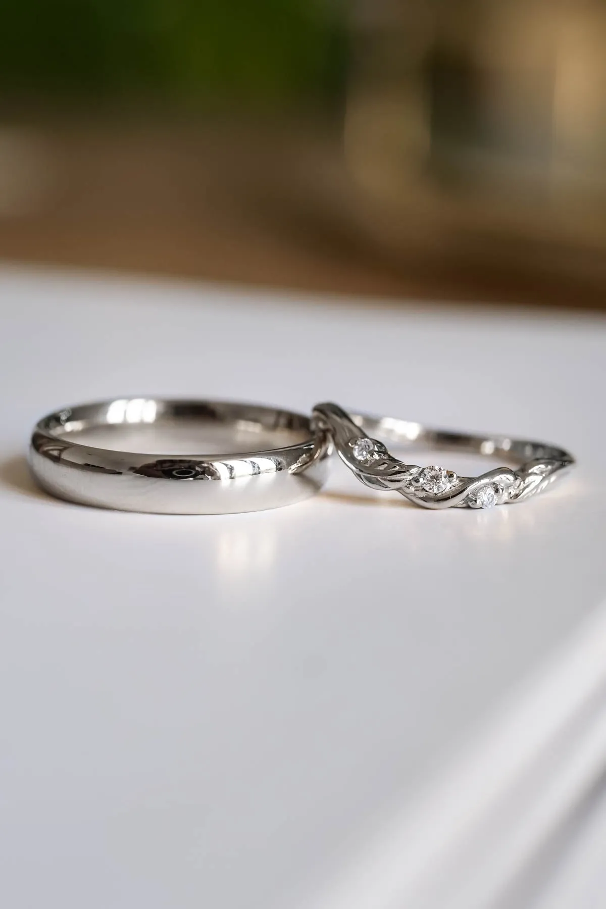 Wedding rings set for couples: classic band for him, curved leaf band for her