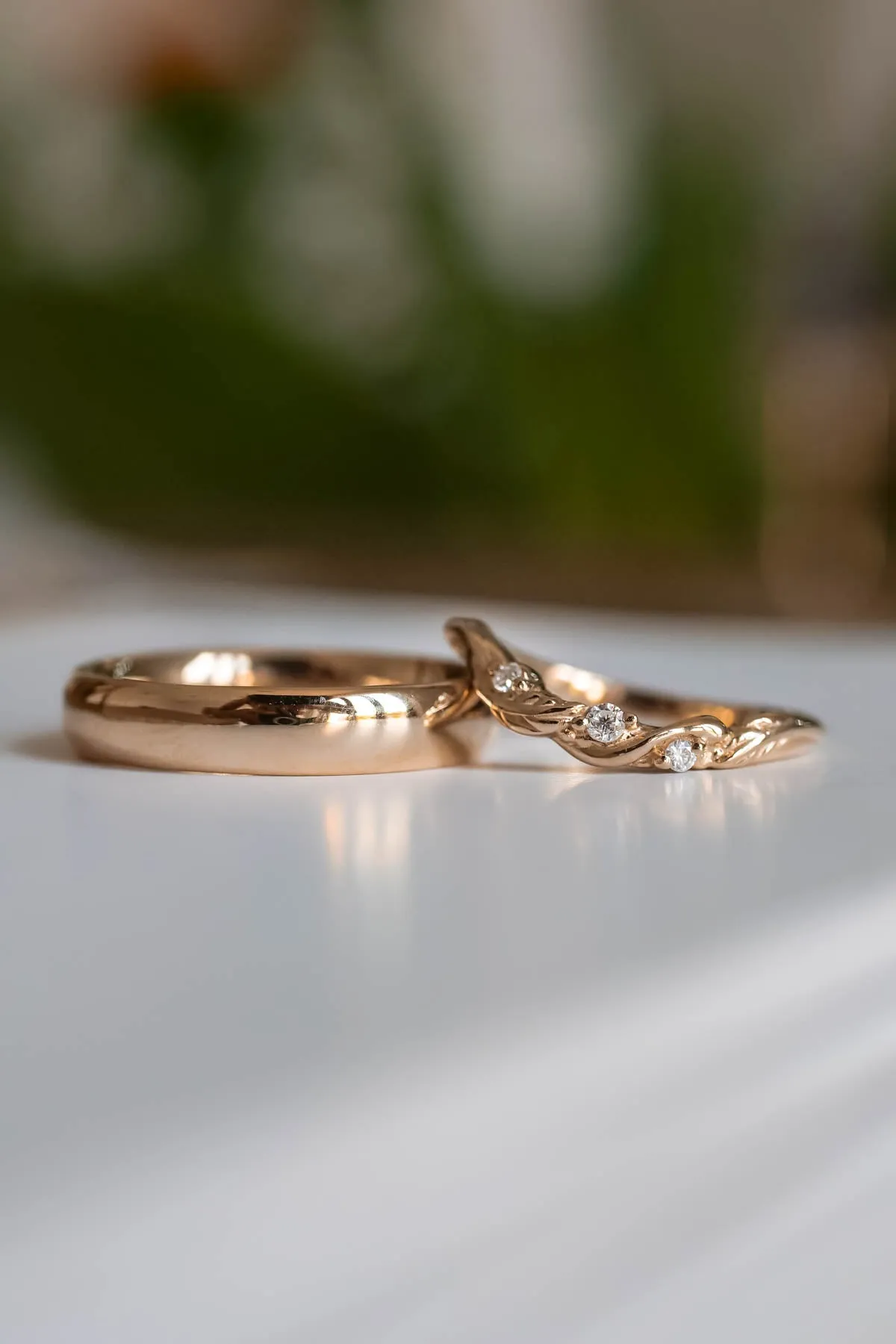 Wedding rings set for couples: classic band for him, curved leaf band for her