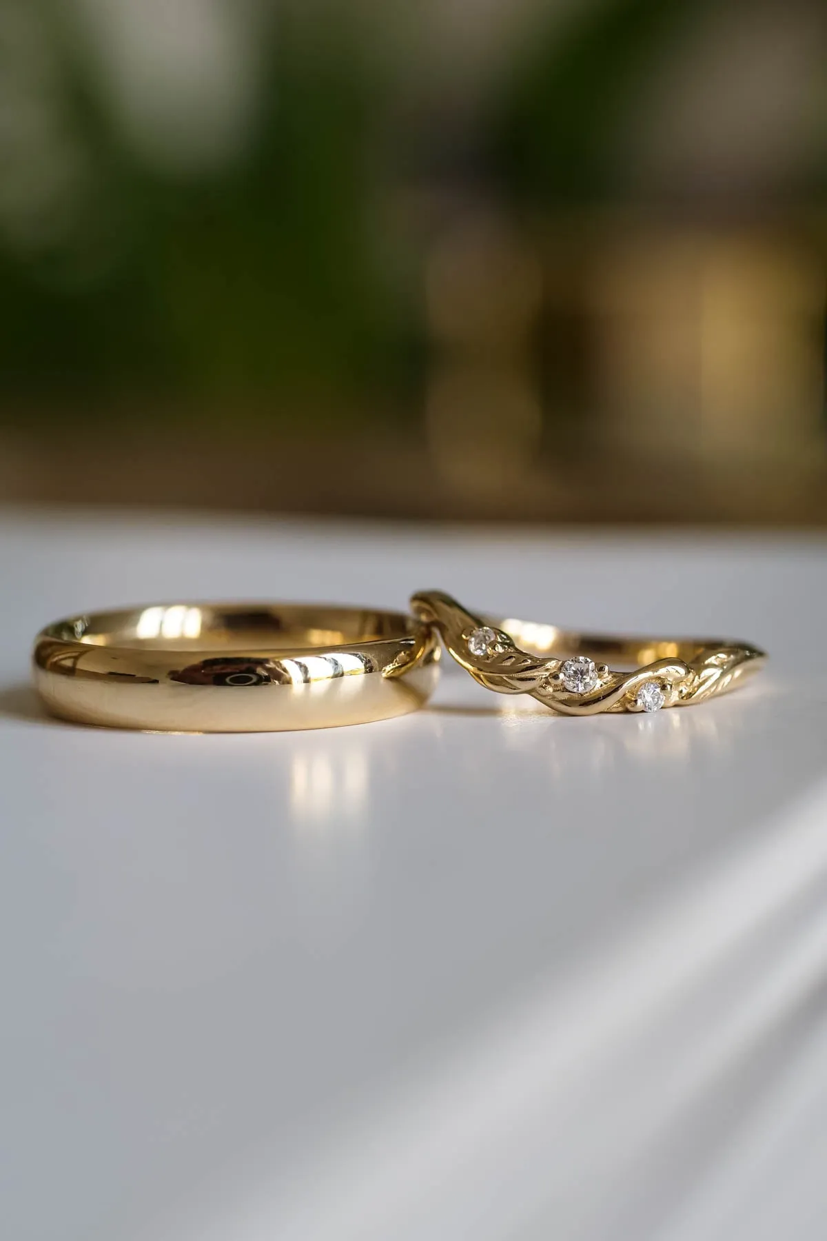 Wedding rings set for couples: classic band for him, curved leaf band for her