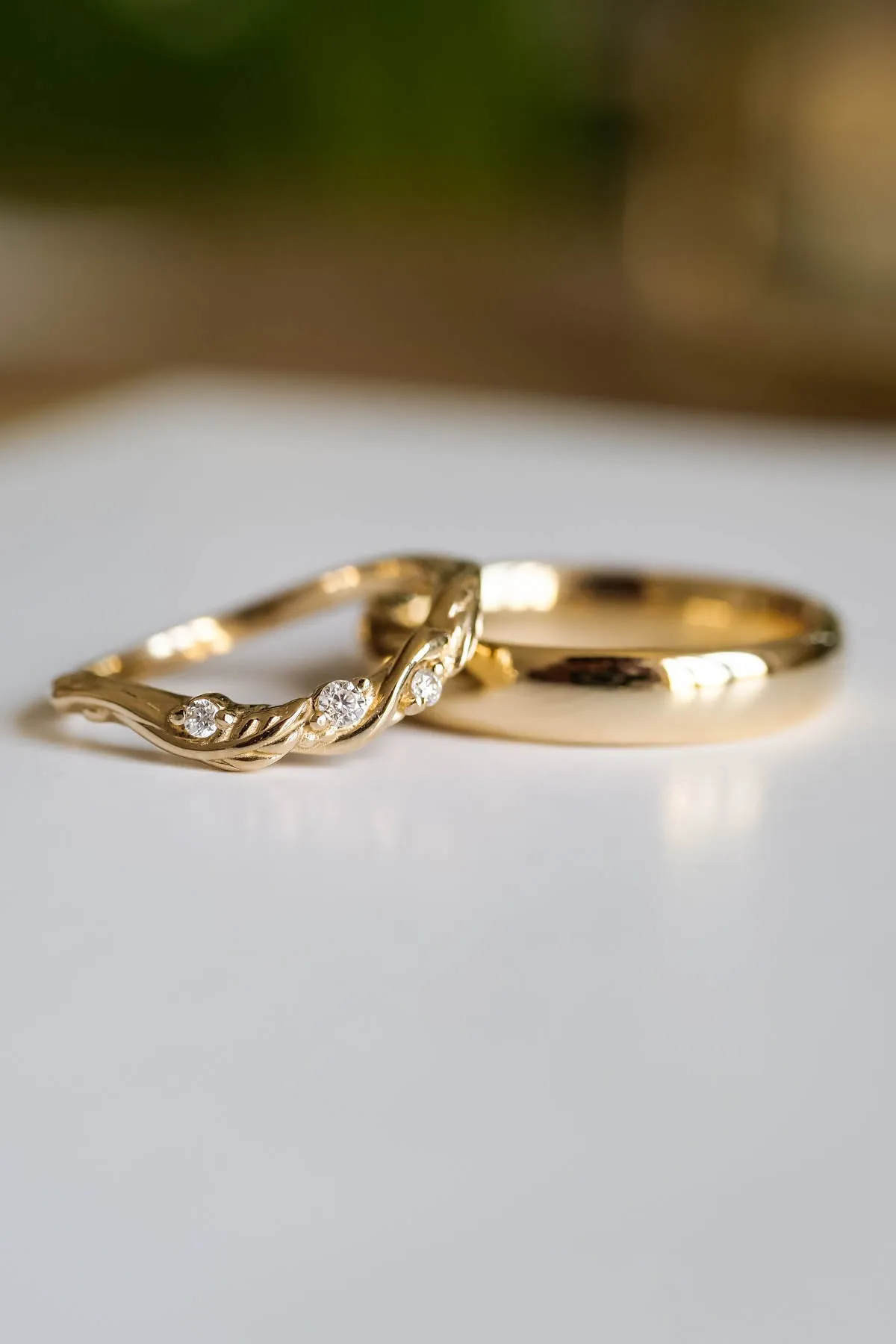 Wedding rings set for couples: classic band for him, curved leaf band for her